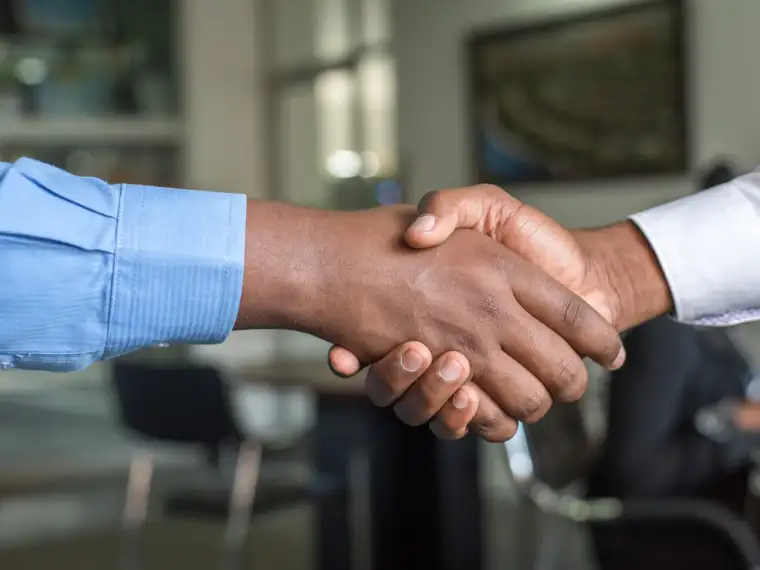 Business associates shaking hands after a deal